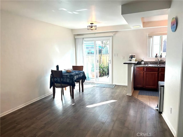 dining space featuring plenty of natural light, dark hardwood / wood-style flooring, and sink