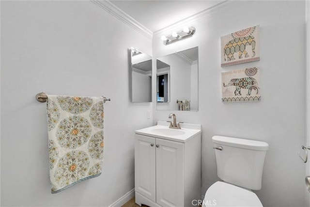 bathroom featuring vanity, crown molding, and toilet