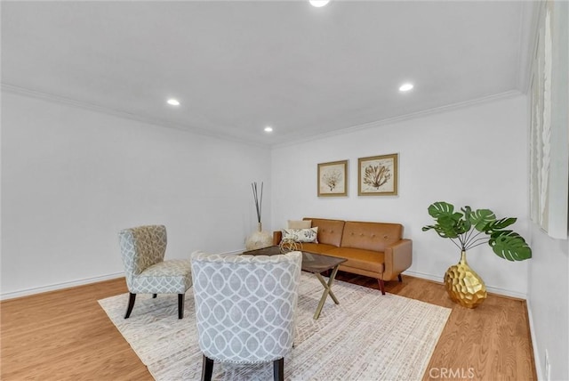 living room with hardwood / wood-style floors and ornamental molding