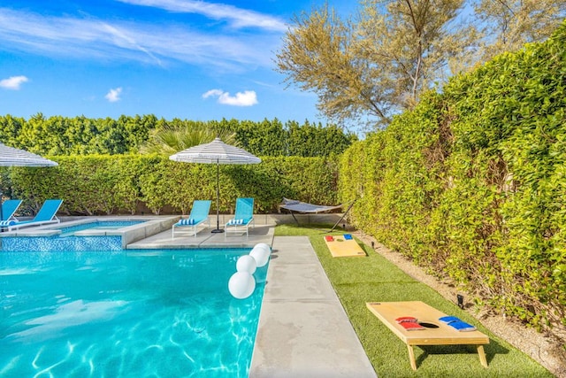 view of pool featuring an in ground hot tub and a patio