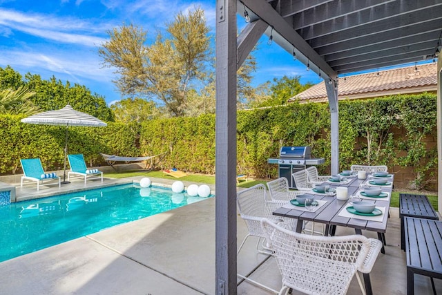 view of pool featuring a grill and a patio