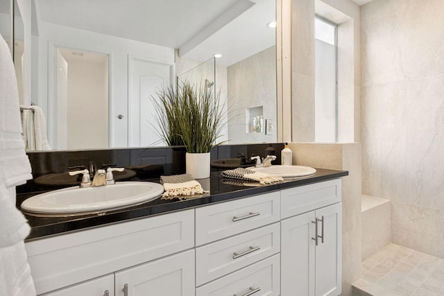 bathroom featuring vanity, tile walls, and tiled shower