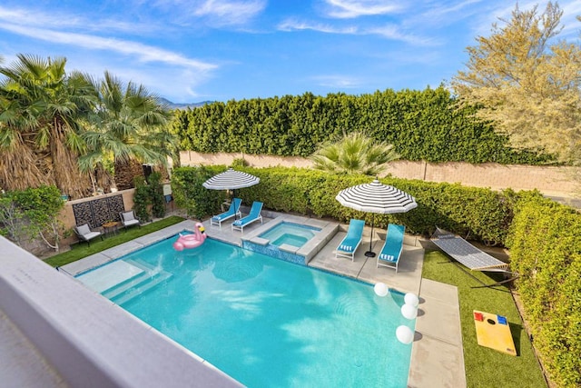 view of swimming pool featuring an in ground hot tub