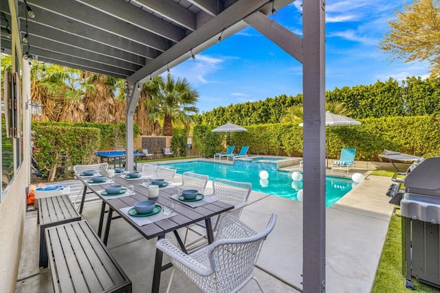 view of swimming pool with area for grilling, a patio, and an in ground hot tub