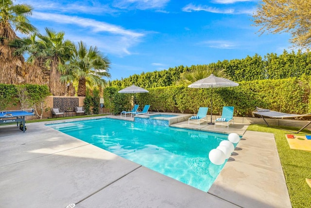 view of pool with a patio area and an in ground hot tub