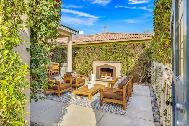 view of patio featuring an outdoor living space with a fireplace