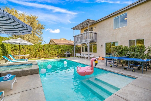 view of swimming pool with an in ground hot tub, grilling area, and a patio