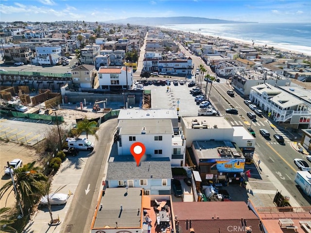 drone / aerial view featuring a water view and a view of the beach