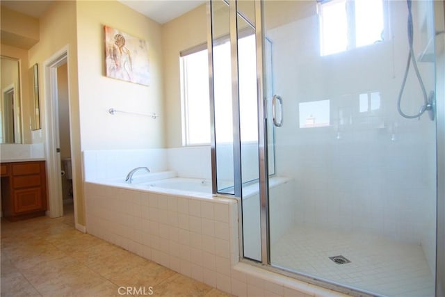 full bathroom with vanity, tile patterned floors, independent shower and bath, and toilet