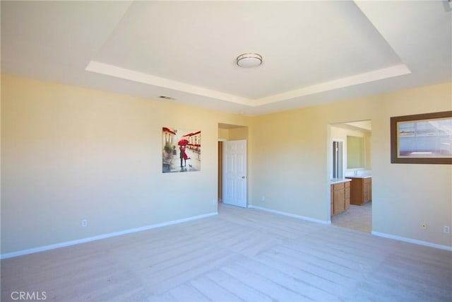 spare room featuring a raised ceiling