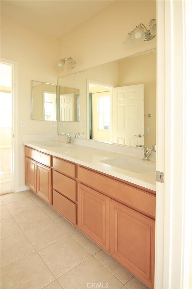 bathroom with tile patterned flooring, vanity, and plenty of natural light