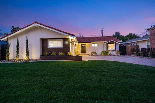 ranch-style house with a lawn