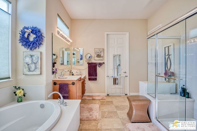 bathroom with vanity and separate shower and tub