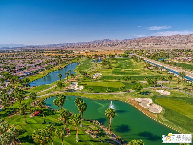 birds eye view of property with a water and mountain view