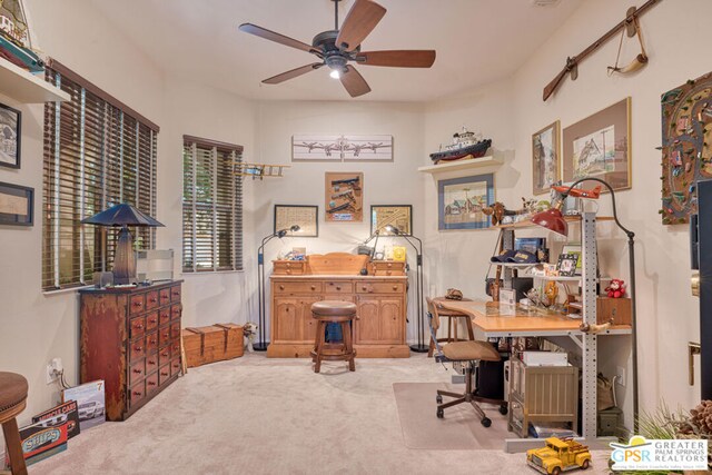 office featuring ceiling fan and light carpet