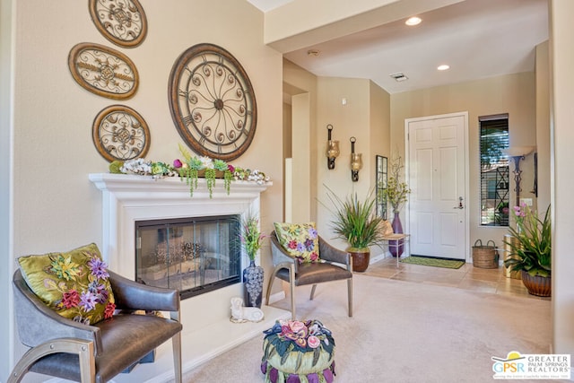 living area featuring light carpet