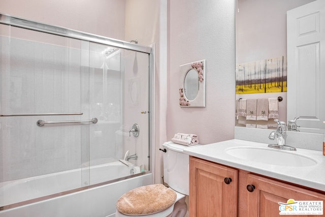 full bathroom featuring shower / bath combination with glass door, vanity, and toilet