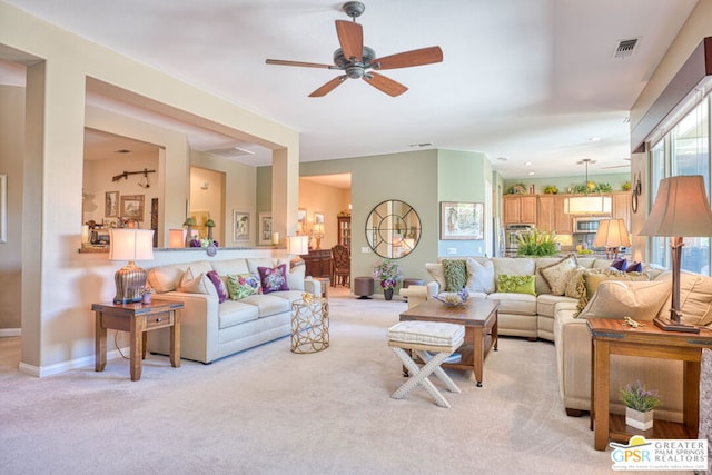 living room with light carpet and ceiling fan