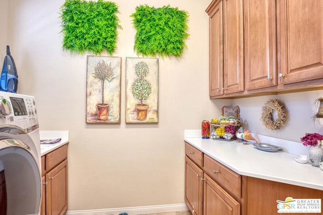 laundry area featuring cabinets and washer / clothes dryer