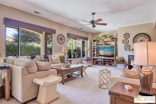 living room with light colored carpet and ceiling fan