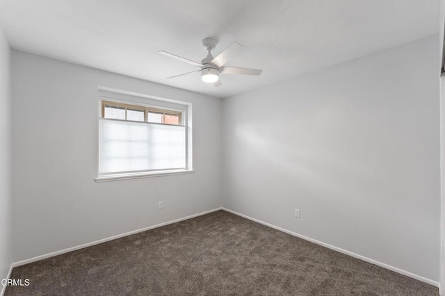 empty room with ceiling fan and dark colored carpet