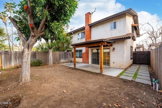 rear view of property featuring a patio area