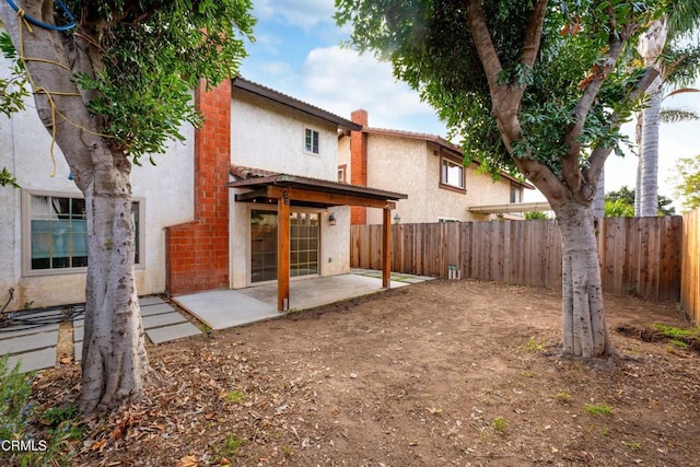 back of house with a patio