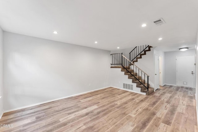 empty room with light hardwood / wood-style flooring