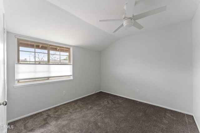 carpeted empty room featuring lofted ceiling and ceiling fan