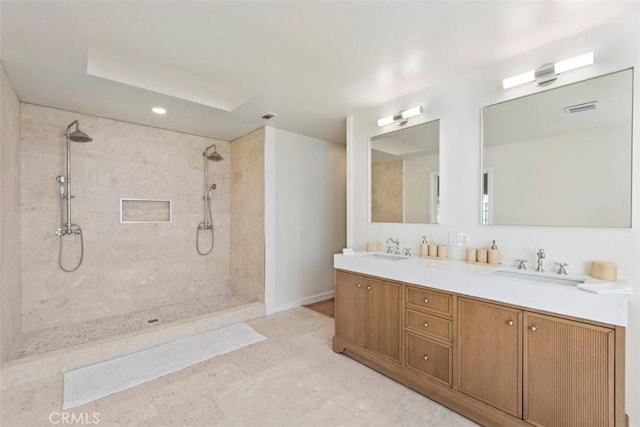 bathroom featuring vanity and tiled shower