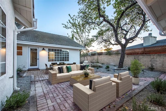 patio terrace at dusk with an outdoor living space