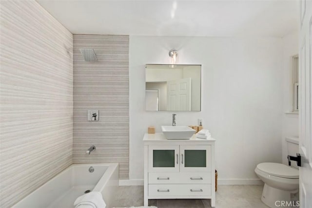 full bathroom with tiled shower / bath, vanity, and toilet