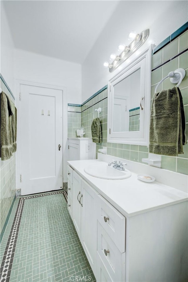 bathroom featuring tile patterned flooring, vanity, tile walls, and decorative backsplash