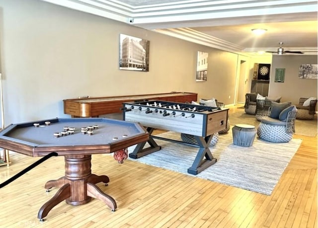 recreation room featuring crown molding, ceiling fan, and light hardwood / wood-style flooring