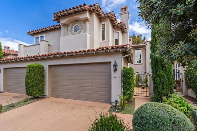 mediterranean / spanish house with a garage