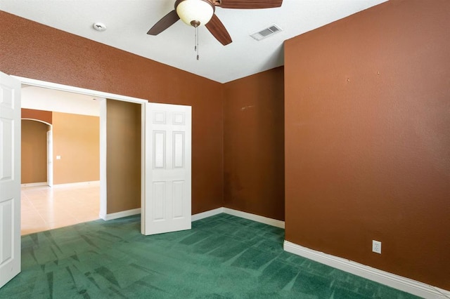 unfurnished bedroom with ceiling fan and carpet floors