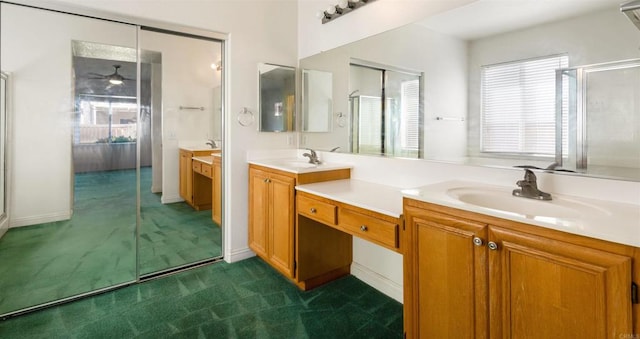 bathroom featuring ceiling fan, vanity, and an enclosed shower