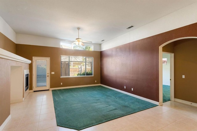 tiled empty room with ceiling fan