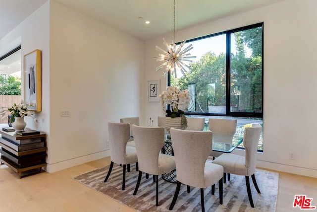 dining room featuring an inviting chandelier and light hardwood / wood-style floors