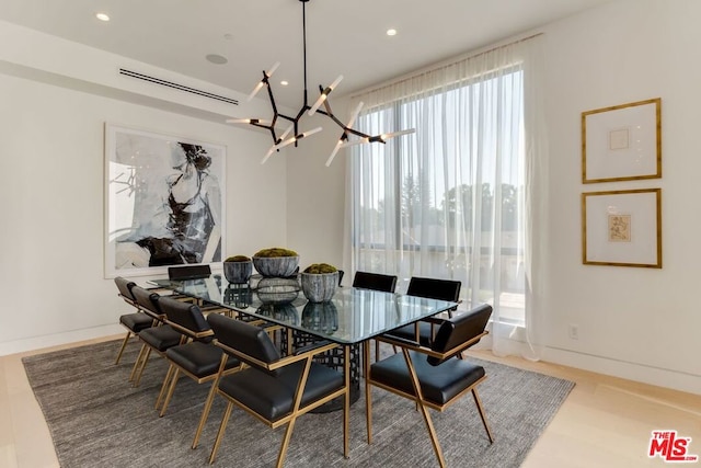 dining space featuring a notable chandelier and light hardwood / wood-style floors