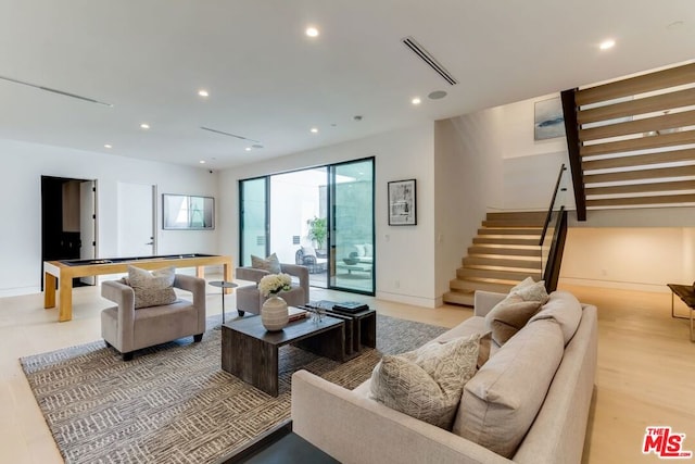 living room with light hardwood / wood-style flooring and billiards