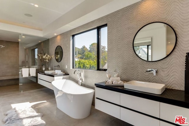 bathroom featuring vanity and a bath