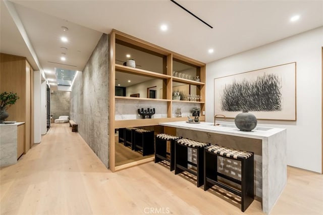 bar with light hardwood / wood-style floors