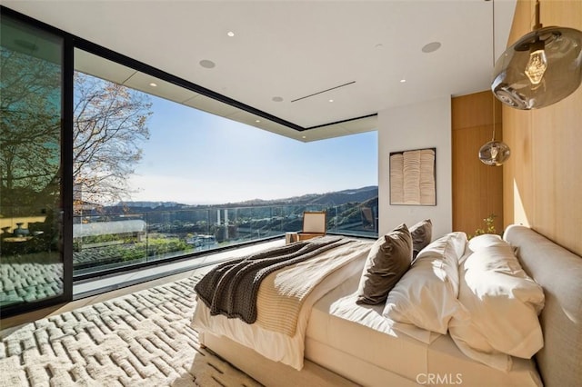 bedroom with a wall of windows and access to exterior