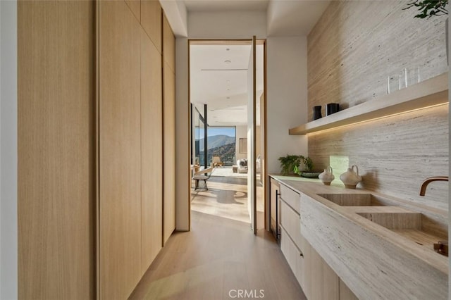 interior space with sink and light hardwood / wood-style flooring