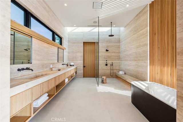 bathroom featuring vanity, shower with separate bathtub, and tile walls