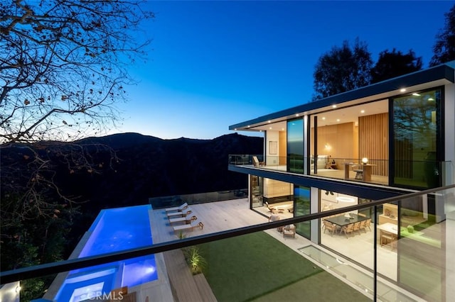 exterior space with a mountain view and a balcony