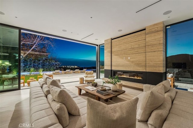 living room featuring a fireplace and floor to ceiling windows