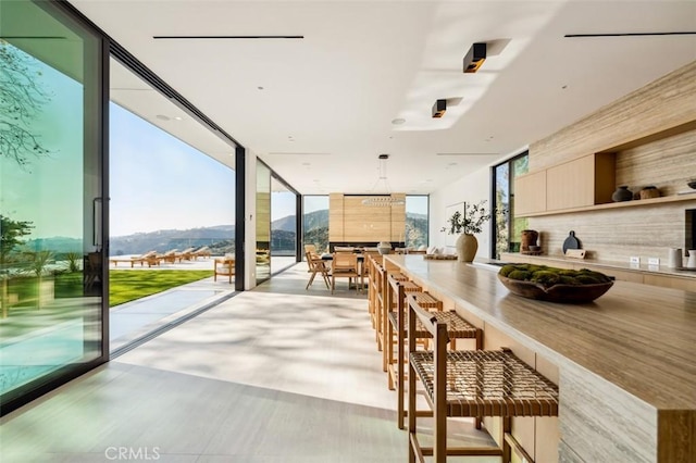 dining space with expansive windows and a mountain view