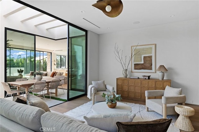 living room with floor to ceiling windows and light hardwood / wood-style flooring